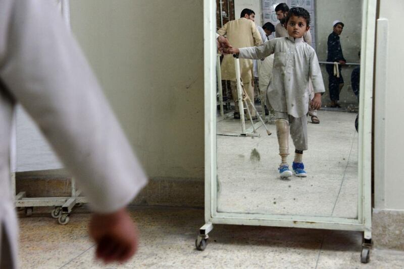 An Afghan child amputee practices walking with his prosthetic leg at one of the International Committee of the Red Cross (ICRC) hospitals for war victims and the disabled in Jalalabad. Noorullah Shirzada / AFP