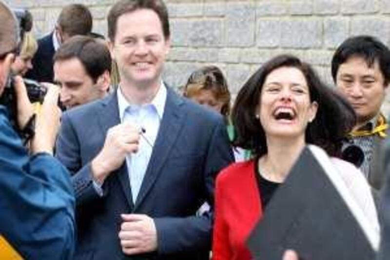 STREET, UNITED KINGDOM - MAY 01:  Liberal Democrat leader Nick Clegg accompanied by his wife Miriam Gonzalez Durantez (R) laughs as he hands back a radio microphone he had been wearing during a visit to the key marginal seat of Wells on May 1, 2010 in Street, United Kingdom. The General Election, to be held on May 6, 2010, is set to be one of the most closely fought political contests in recent times with all main party leaders embarking on a four week campaign to win the votes of the United Kingdom electorate.  (Photo by Matt Cardy/Getty Images) *** Local Caption ***  GYI0060320056.jpg