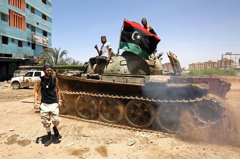 Members of the Libyan National Army drive a tank during clashes with jihadists in Benghazi's Al-Hout market area. Abdullah Doma / AFP