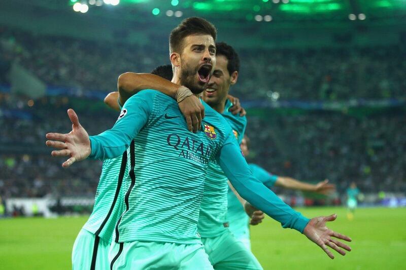 Gerard Pique of Barcelona celebrates with teammates Luis Suarez and Sergio Busquets after scoring his team’s second goal. Alex Grimm / Getty Images