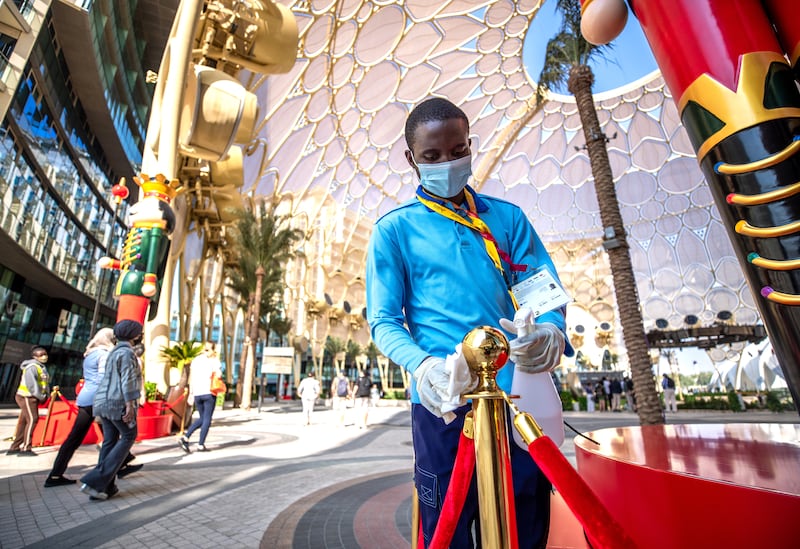 A cleaner uses sanitiser around Al Wasl Plaza at Expo. Victor Besa / The National