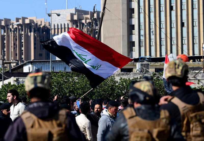 Iraqi soldiers stand guard as Iraqi university students chant slogans as they take part in a demonstration in front of the Iraqi ministry of higher educations in Baghdad, Iraq, 14 January 2020. EPA