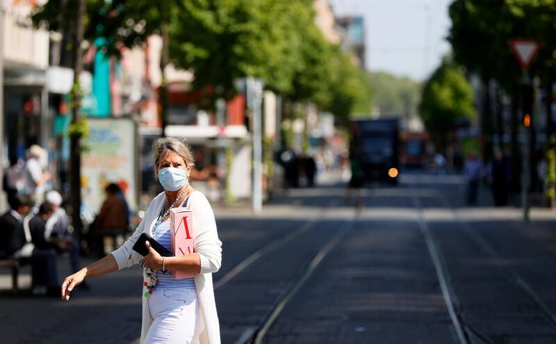 epa08386552 A woman wearing a protective face mask walks on the so-called 'Planken' street in Mannheim, Germany, 27 April 2020, amid the ongoing coronavirus COVID-19 pandemic. From today on, the wearing of face masks is obligatory in Baden-Wuerttemberg and other federal states in Germany. Countries around the world are taking increased measures to stem the widespread of the SARS-CoV-2 coronavirus which causes the COVID-19 disease.  EPA/RONALD WITTEK