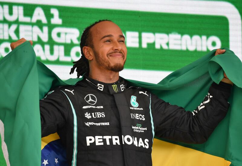 Mercedes' British driver Lewis Hamilton celebrates on the podium after winning Brazil's Formula One Sao Paulo Grand Prix. AFP