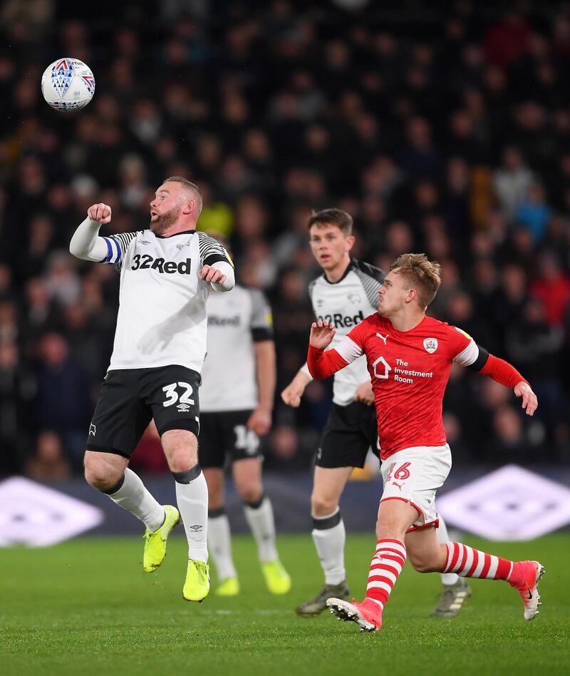 Wayne Rooney attempts to control the ball in front of Luke Thomas of Barnsley. Getty