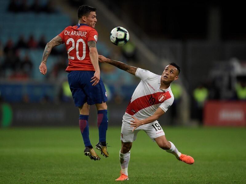 Chile's Charles Aranguiz and Peru's Yoshimar Yotun vie for the ball during their Copa America football tournament semi-final match at the Gremio Arena in Porto Alegre, Brazil. AFP