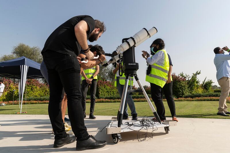 People gather at the Al Thuraya Astronomy Centre in Mushrif Park to watch the event. Antonie Robertson / The National

