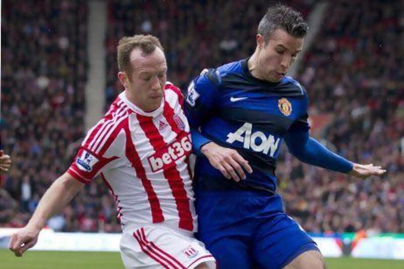 Stoke's Charlie Adam, left, fights for the ball against Manchester United's Robin van Persie. Jon Super / AP Photo