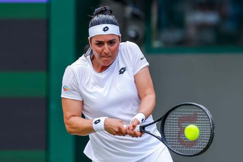 Ons Jabeur hits a forehand to Elise Mertens. EPA