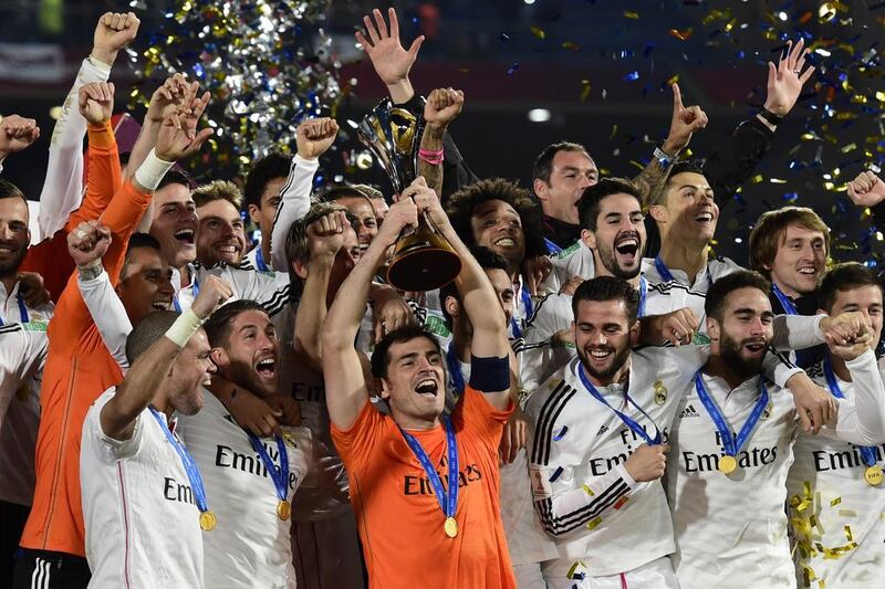 Real Madrid's players celebrate with the trophy after winning the FIFA Club World Cup final football match against San Lorenzo at the Marrakesh stadium in the Moroccan city of Marrakesh on December 20, 2014. AFP PHOTO / JAVIER SORIANO