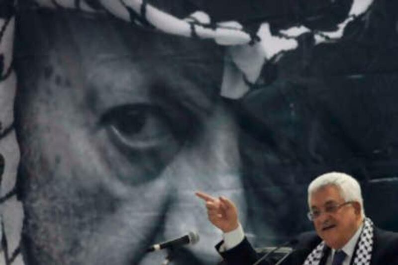 With a portrait of late Palestinian Yasser Arafat on the background Palestinian President Mahmoud Abbas speaks at the Fatah conference in the West Bank town of Bethlehem, Tuesday, Aug. 4, 2009. The Palestinians' Fatah movement came together Tuesday for its first convention in 20 years, trying to rise from division and defeat with a pragmatic political program and new leaders, in what its supporters hope will be the final push toward Palestinian statehood. (AP Photo/Tara Todras-Whitehill) 