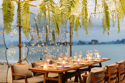 A dinner table set up overlooking the bay