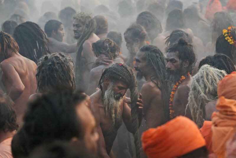 Naked Hindu holy men or a Naga Sadhus dry their hairs after a dip at Sangam, the confluence of the Rivers Ganges, Yamuna and mythical Saraswati on one of the most auspicious day Makar Sankranti,  the first day of the Maha Kumbh Mela, in Allahabad, India, Monday, Jan. 14, 2013. Millions of Hindu pilgrims are expected to take part in the large religious congregation of a period of over a month on the banks of Sangam during the Maha Kumbh Mela in January 2013, which falls every 12th year, where devotees wash themselves in the waters of the Ganges believing that it washes away their sins and ends the process of reincarnation. (AP Photo /Manish Swarup) *** Local Caption ***  India Maha Kumbh.JPEG-07a57.jpg