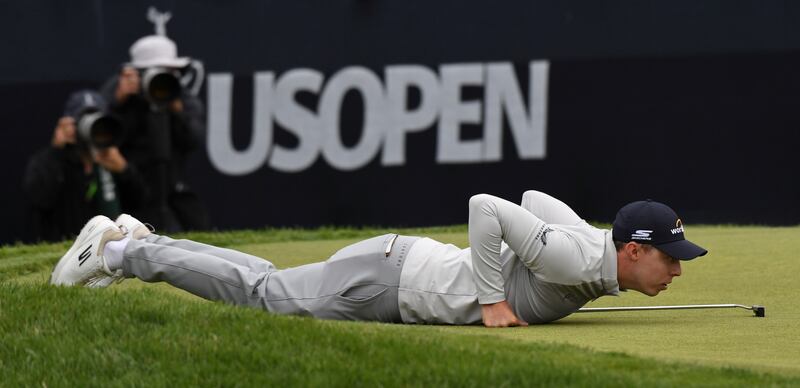 Matt Fitzpatrick of England lines up a shot on the 15th green. EPA