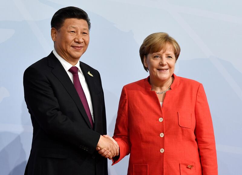 Mrs Merkel with the Chinese President Xi Jingping. John MacDougall / AFP Photo