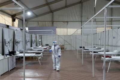 A woman wearing a protective suit is seen inside a hospital that has been constructed to treat patients who test positive for the coronavirus disease (COVID-19), during an extended lockdown to slow its spread, in Mumbai, India, May 22, 2020. REUTERS/Francis Mascarenhas