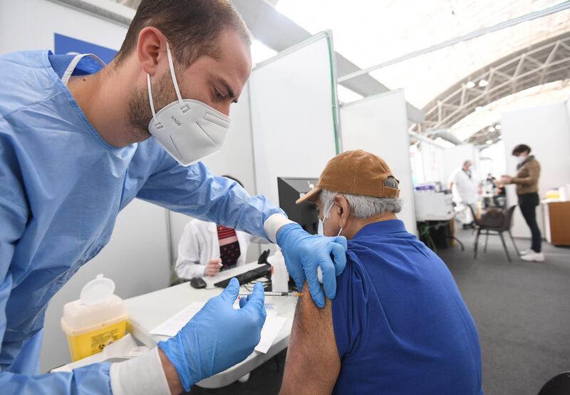 A health care worker administers a vaccine to a Lombard citizen at the vaccination hub in Novegro, near Milan, Italy. EPA