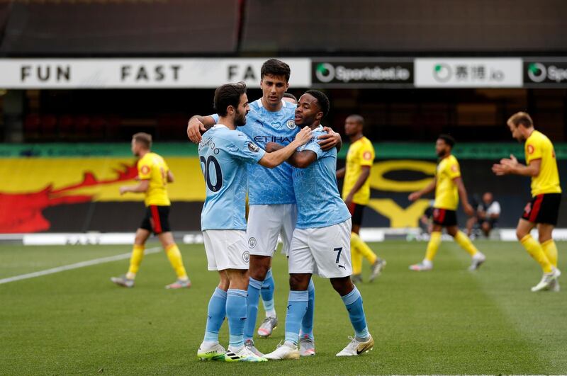 Manchester City's Raheem Sterling, right, celebrates with teammates after scoring his side's opening goal against Watford at the Vicarage Road Stadium. AP