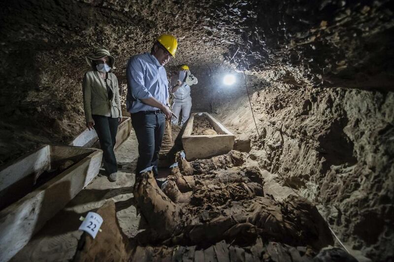 Egyptian Antiquities Minister Khaled El Enany (C)  on May 13, 2017, in front of mummies following their discovery in catacombs in the Touna El Gabal district of the Minya province, in central Egypt.  Khaled Desouki / AFP 

