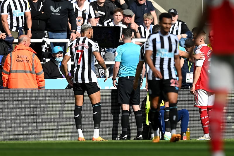 Referee Chris Kavanagh checks the VAR monitor before overturning a penalty awarded to Newcastle. Getty 
