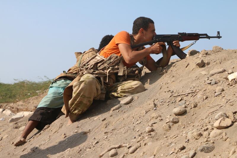 Yemeni pro-government forces take a position during fighting near Hodeidah. EPA