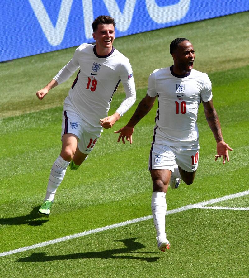 England's Raheem Sterling, right, reacts as he celebrates with teammate Mason Mount after scoring his team's first goal. AP