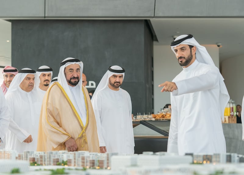 The Ruler of Sharjah, Sheikh Dr Sultan bin Muhammad Al Qasimi, is shown a new housing and business development by Sheikh Sultan bin Ahmed, right, in 2020. The National