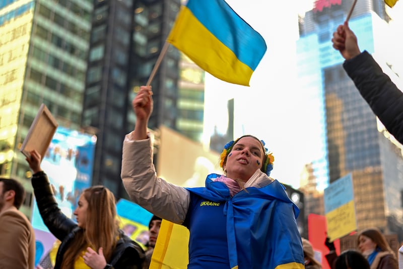 A woman waves a Ukrainian flag during a rally in Times Square, New York City. AFP