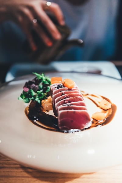 Tuna sashimi in oak smoke is just one of the wow-worthy dishes on offer at Abu Dhabi's 99 Sushi Restaurant & Bar. Courtesy 99 Sushi Restaurant & Bar