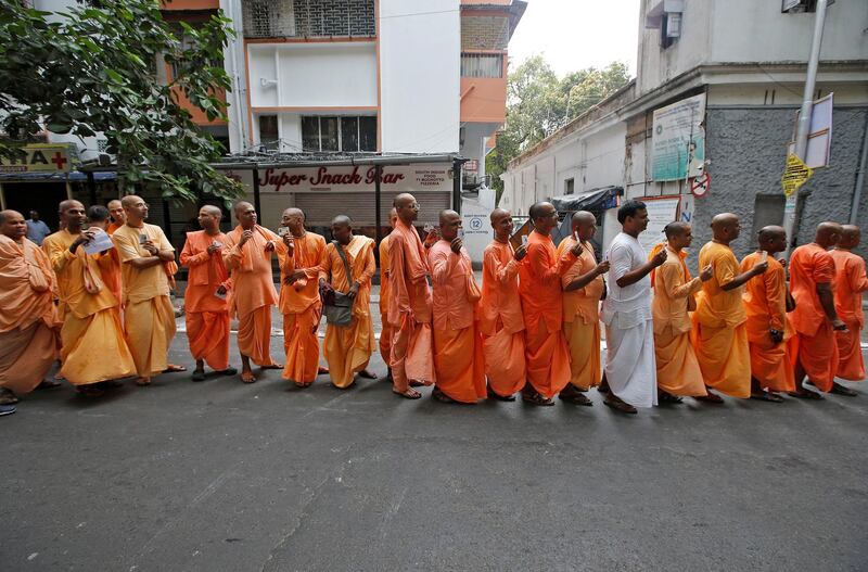 Hindu holy men stand in a queue outside a polling station to caste their vote during the final phase of general election in Kolkata, India.  Reuters