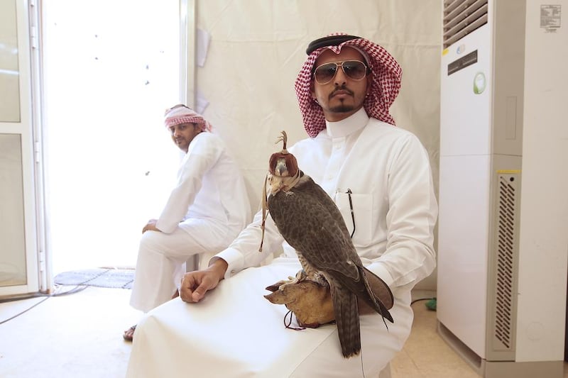 Abdel Karim Al Rashid, of Saudi Arabia, with his falcon at the Fazza Championship for Falconry, in Dubai. Jeffrey E Biteng / The National