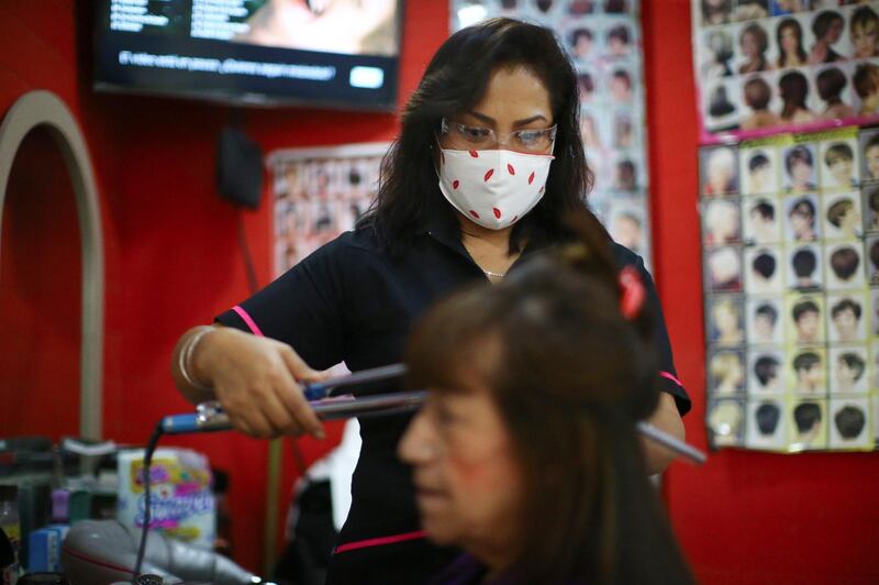 A stylist combs a woman's hair at "Imagen" beauty salon in Mexico City, Mexico. Reuters