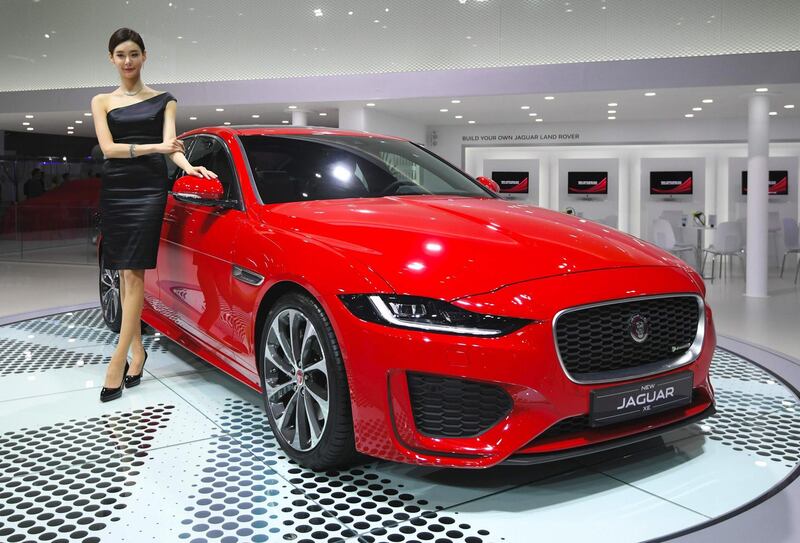 A model poses with a Jaguar XE at the show. Jung Yeon-Je / AFP
