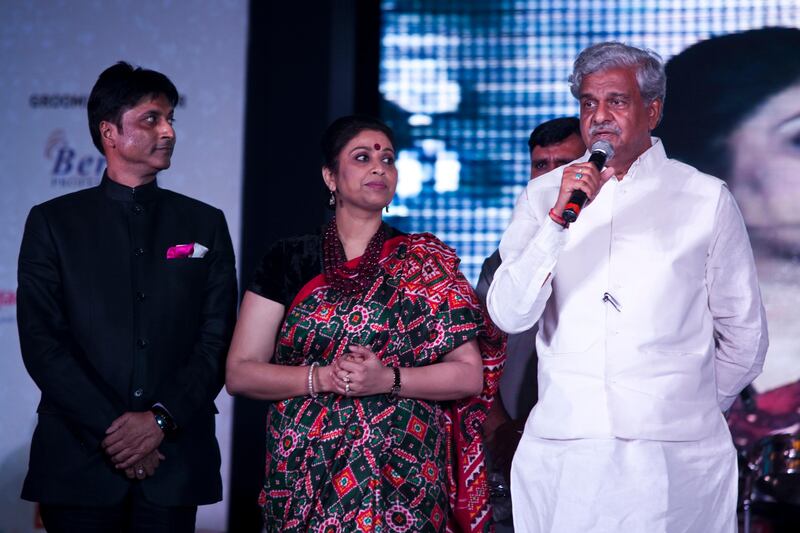 Virendra Kumar Goel (left), convener of AAS, and Varsha Goel (center), founder and president of AAS stand next to Sriprakash Jaiswal, the Minister of State for Coal as he gives a speech at the inaugural AAS Housewives Awards 2012 on 19th May 2012 in New Delhi, India. Photo by Suzanne Lee for The National