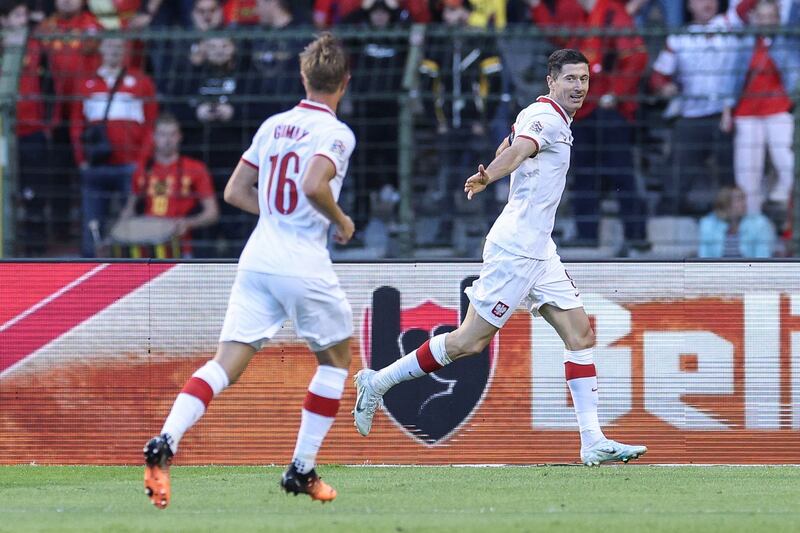 Robert Lewandowski celebrates with Robert Gumny after scoring for Poland against Belgium. AFP