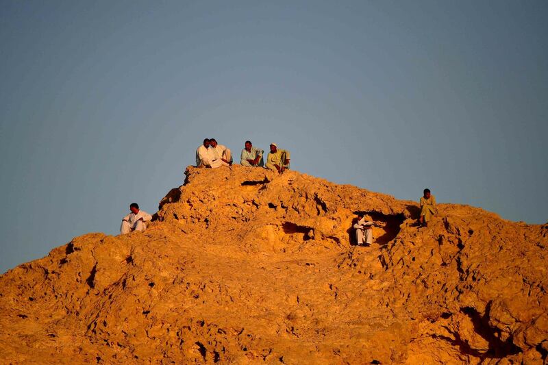 People gather on a hilltop during the match at the Khalifa bin Zayed Stadium in Al Ain. AFP