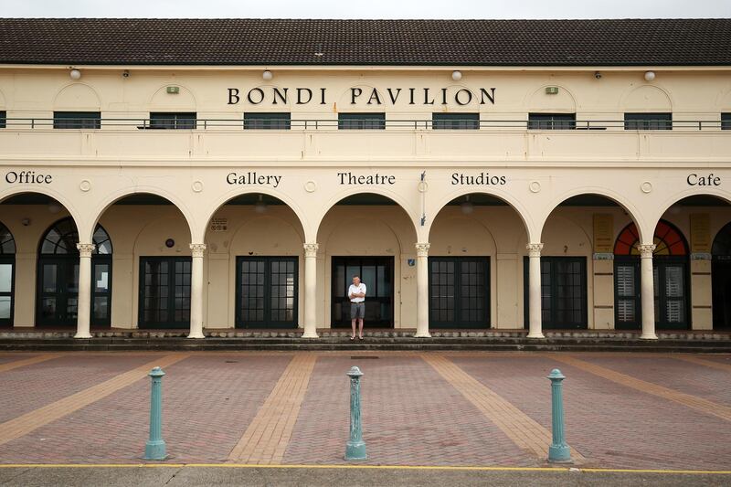 A man stands outside the Bondi Pavilion at a near-empty Bondi Beach in Sydney, Australia. Bloomberg