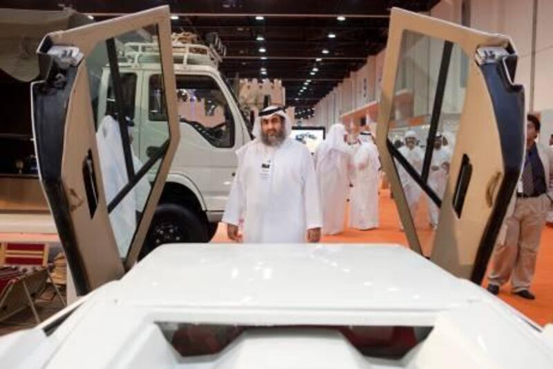 September 23, 2010, Abu Dhabi, UAE: Inside of ADNEC at the anual ADHIX exhibition is a booth of Emirate made ATVs. Seen here is Dr. Hajeri' standing in front of the first car he ever made(it took one year for him to make it). He began making cars in 1988, is a Father of 11 and Chairman of the Gulf Automobile Industry Corporation.

Lee Hoagland / The National