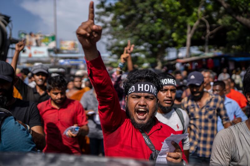 Protesters in Colombo, Sri Lanka, on Tuesday call for acting president and Prime Minister Ranil Wickremesinghe to resign. AP