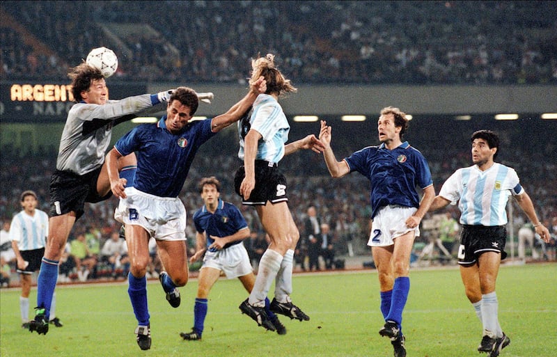 Argentinian forward Claudio Caniggia (C) scores on a header as Italian goalkeeper Walter Zenga comes up short (R) 03 July 1990 in Naples during the World Cup semifinal soccer match between the two countries. Argentina advanced to the final 4-3 on penalty kicks at the end of extra time (1-1 at the end of regulation time). At right, defender Franco Baresi and midfielder Diego Maradona.  AFP PHOTO / AFP PHOTO / STAFF