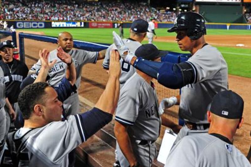 ATLANTA, GA - JUNE 12: Alex Rodriguez #13 of the New York Yankees is congratulated by teammates after hitting an 8th inning grand slam against the Atlanta Braves at Turner Field on June 12, 2012 in Atlanta, Georgia.   Scott Cunningham/Getty Images/AFP== FOR NEWSPAPERS, INTERNET, TELCOS & TELEVISION USE ONLY ==

