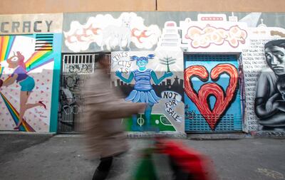 A woman walks by an economic-themed mural in San Francisco, California on February 6, 2019.  San Francisco, once home to flower power, hippies and dope, has changed dramatically: these days, it is all about Facebook, Twitter and Google, the multi-billion dollar tech giants who have turned it into one of the world's most expensive cities to live in.  
Average monthly rent for a two-room apartment in the city by the bay now runs to $3,700, the highest in the United States. And a household of four with annual earnings of less than $117,400 is officially officially considered "low income." "We see now a kind of homelessness that did not occur before, people who work, that is new,” said Cary McClelland, author of the 2018 book "Silicon City"  which examines how the city has changed. 
 / AFP / Josh Edelson / TO GO WITH AFP STORY by JULIE CHARPENTRAT -  "Even San Francisco homeless not spared in the age tech disruption "
