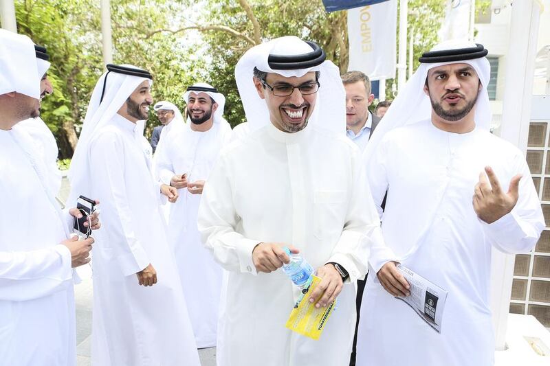 Hamad Buamim, centre, president and CEO of Dubai Chamber of Commerce & Industry, tours the various food truck concepts. Sarah Dea / The National