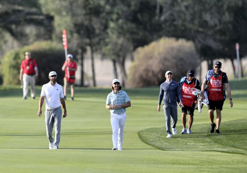 Abu Dhabi, United Arab Emirates - January 18th, 2018: Golfer Tommy Fleetwood, Dustin Johnson (L) and Rory McIlroy (R) in action at the Abu Dhabi HSBC Championship. Thursday, January 18th, 2018 at Abu Dhabi Golf Club, Abu Dhabi. Chris Whiteoak / The National
