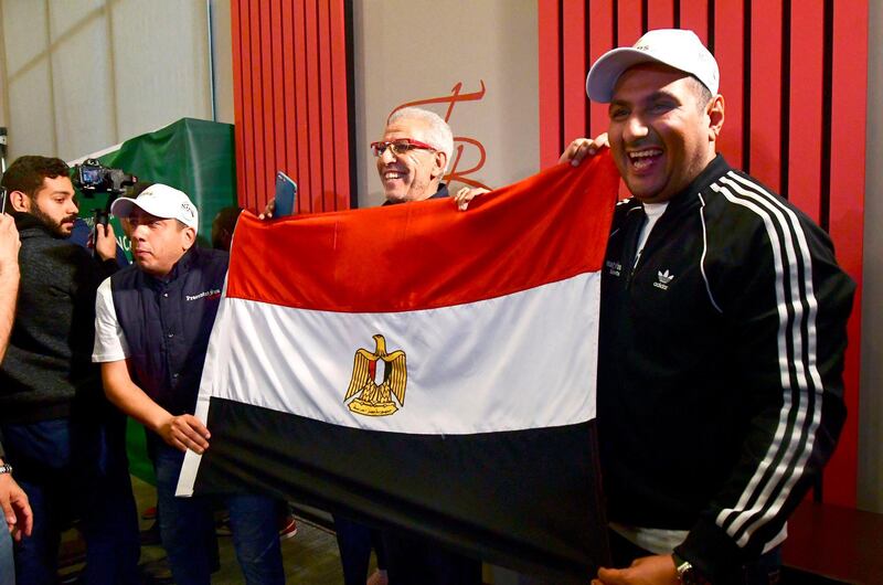 Egyptian representatives pose with their national flag as they celebrate the Confederation of African Football (CAF) executive committee's decision to choose Egypt to host the 2019 Africa Cup of Nations between June 15 and July 13, in an Hotel in Dakar on January 8, 2019. The CAF executive committee preferred Egypt to South Africa as replacements for original hosts Cameroon, who were dropped due to delays in preparations and concerns over security. It will be the fifth time Egypt stage the biennial showpiece of African football after 1959, when the country was called the United Arab Republic, 1974, 1986 and 2006.
 / AFP / SEYLLOU
