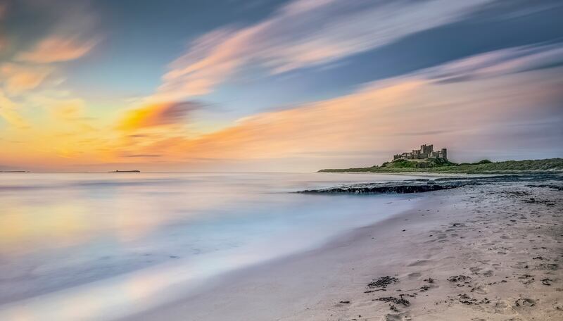 6. Early morning views of the shore line and beach near to Bamburgh Castle in Northumberland, UK.