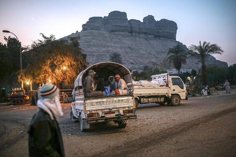 Quarry workers are transported in pickup trucks after dawn from Shurafa village, Minya, southern Egypt. Around 45,000 people, including children, work in an estimated 1,500 quarries, digging out stones that later will be used in construction or powdered to be used by pharmaceutical and ceramic companies. Mosa'ab Elshamy / AP Photo