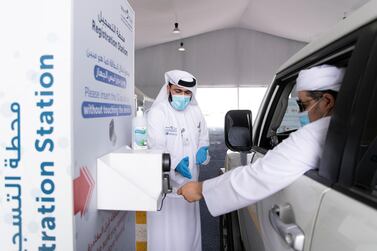 Ras Al Khaimah, UNITED ARAB EMIRATES. 30 APRIL 2020. A man uses his Emirates ID card to register before taking the test at SEHA’s Ras Al Khaimah Covid-19 drive-through testing centre. (Photo: Reem Mohammed/The National) Reporter: Section: