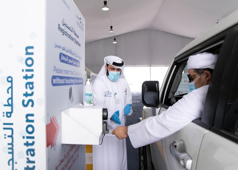 Ras Al Khaimah, UNITED ARAB EMIRATES. 30 APRIL 2020. 
A man uses his Emirates ID card to register before taking the test at SEHA’s Ras Al Khaimah Covid-19 drive-through testing centre.
(Photo: Reem Mohammed/The National)

Reporter:
Section: