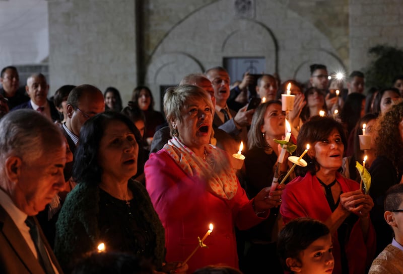 Palestinian Christians attend an Orthodox service during Easter night. AFP